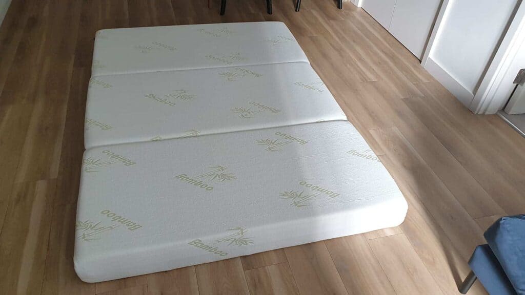 inofia tri folding mattress for guests on floor view