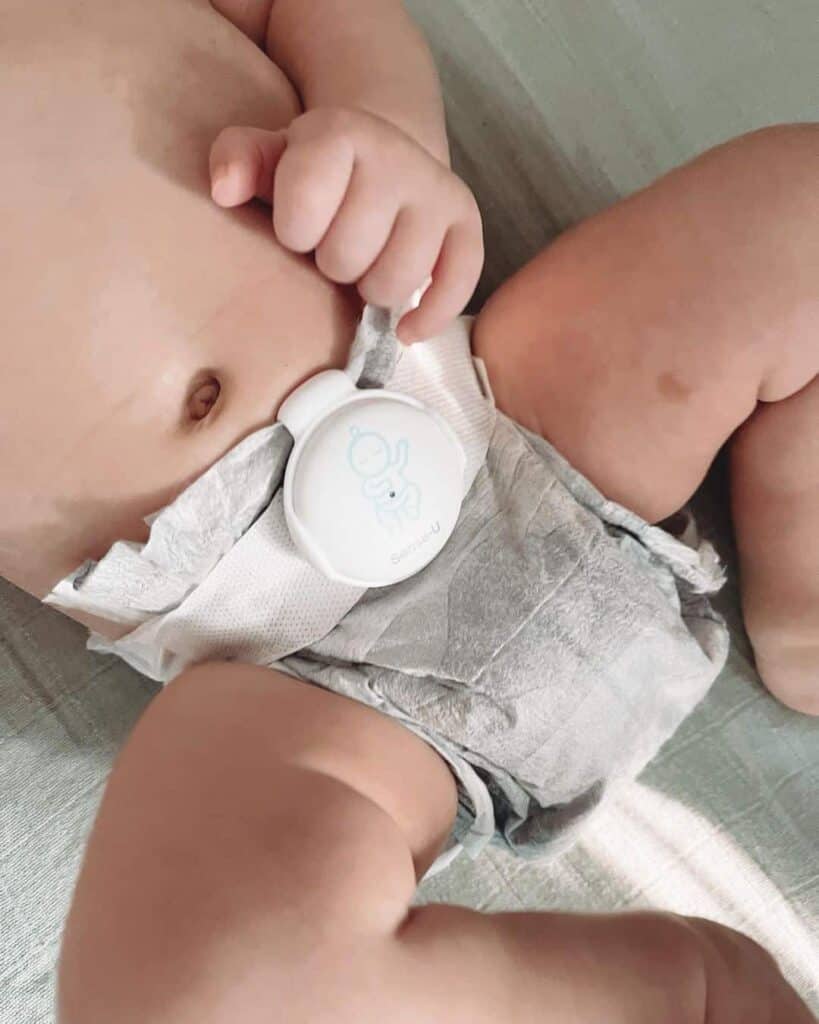 sense u attaches to a babys diaper or sleepwear in the form of a button view
